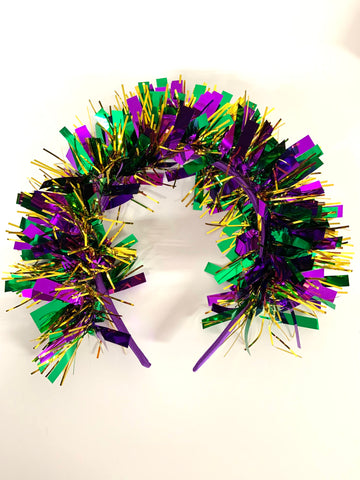 purple headband decorated with Mardi Gras colored tinsel. 